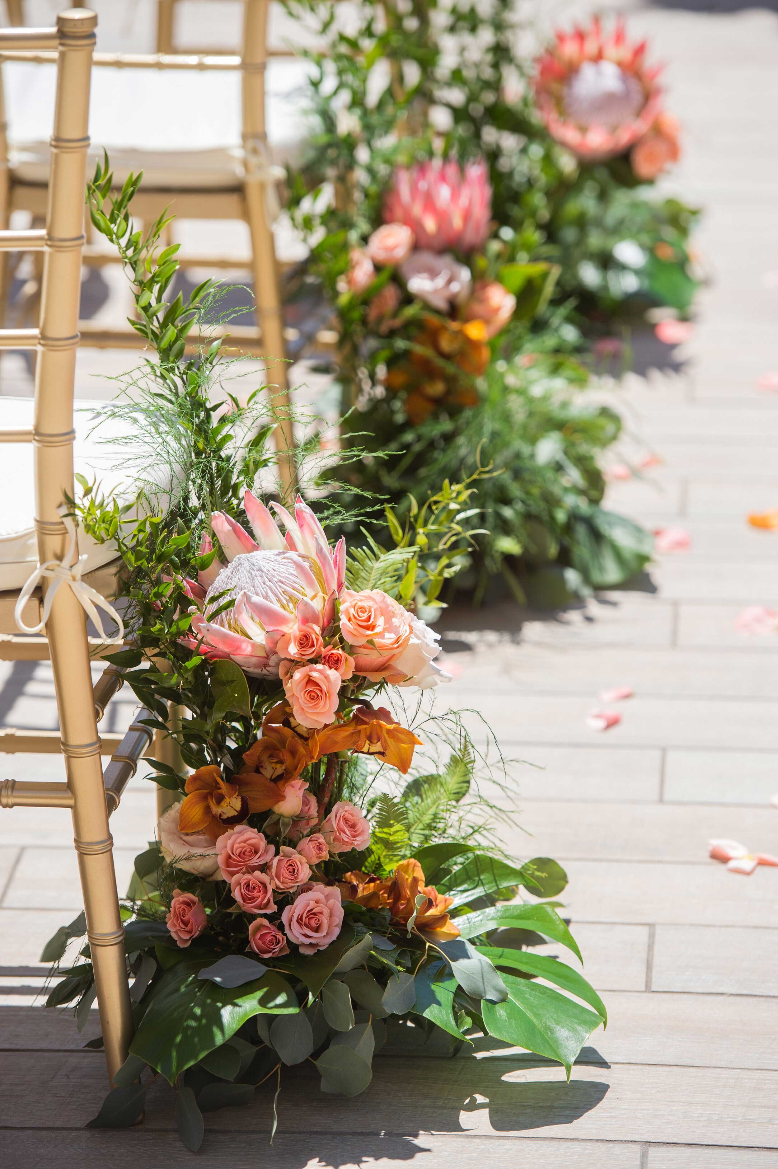 tropical-floral-arrangement-along-wedding-aisle-Queen-Kapiolani-Hotel-Waikiki.jpg