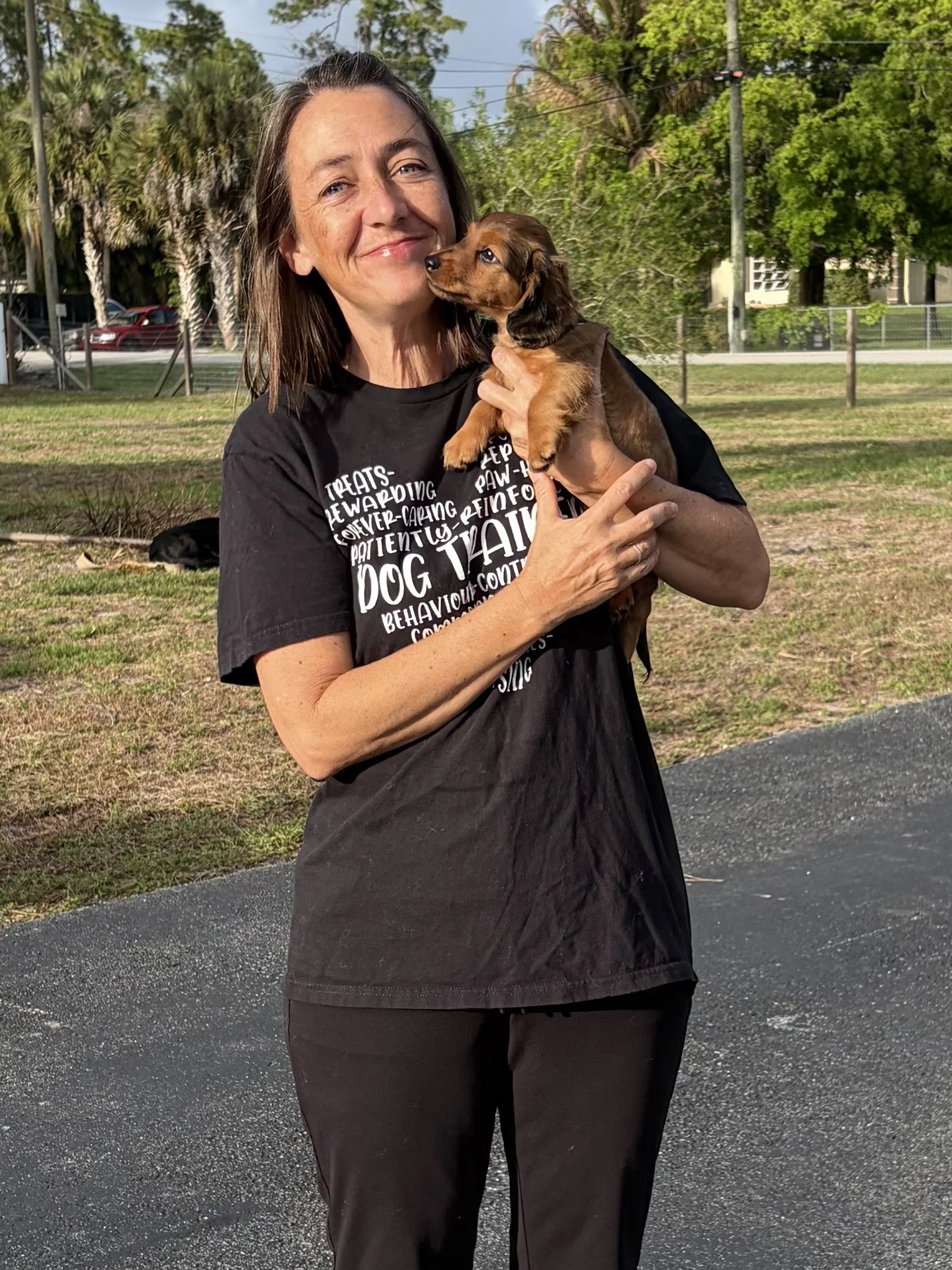 Palm Beach County dog trainer holding a puppy during in-home dog training