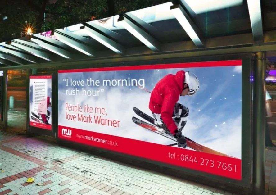 Mark Warner ski advertising campaign on an illuminated bus shelter, featuring the line “I love the morning rush hour”.