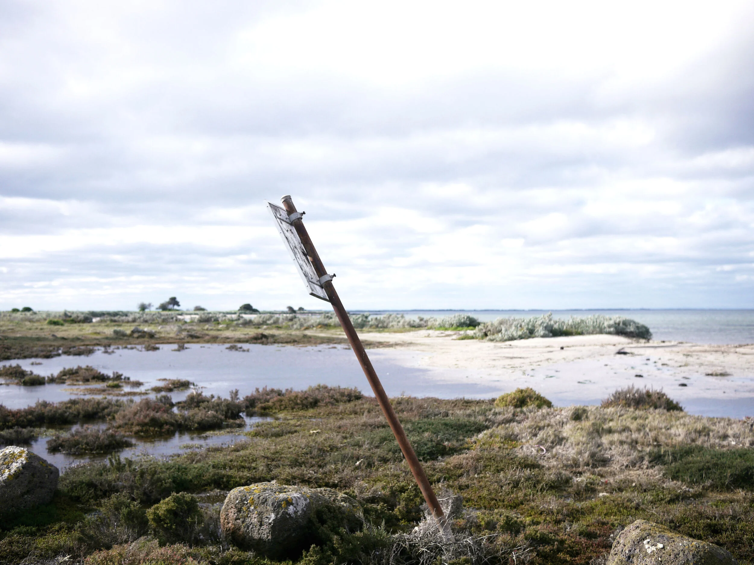 Warped sign along the coast at Point Wilson