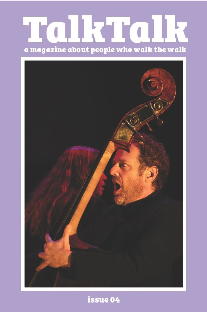 Magazine cover of TalkTalk with the title on top and underneath it says 'a magazine about people who walk the walk'. Underneath is a person holding a double bass guitar with an open mouth. Underneath that is the text 'issue 04'.