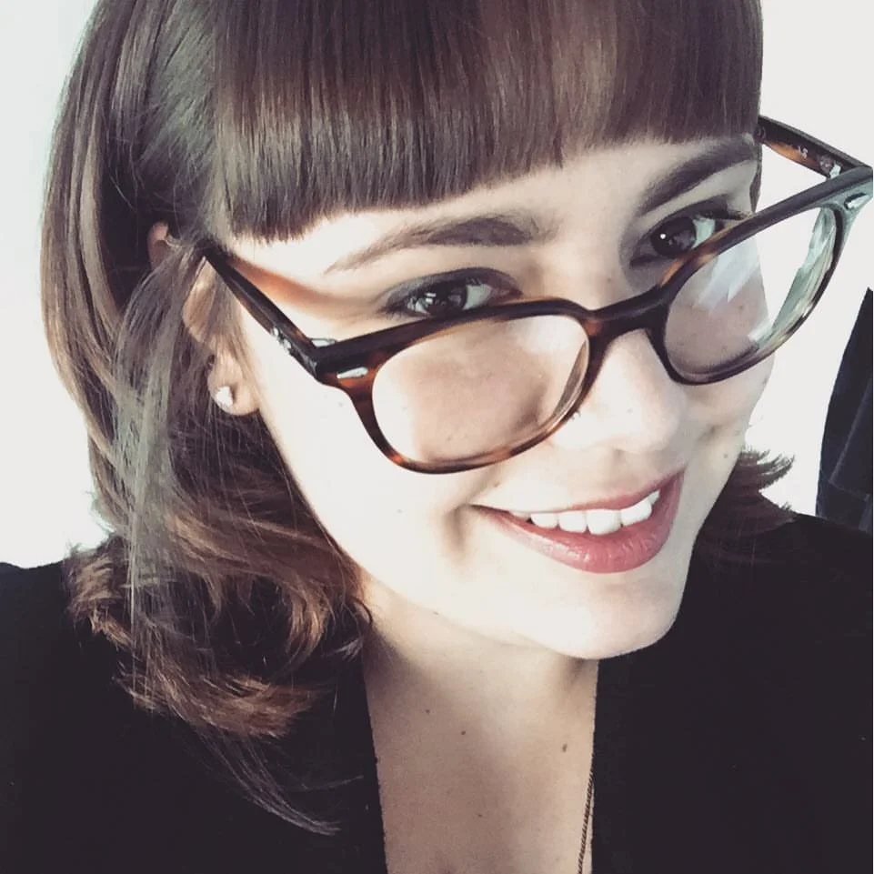 Perrson wearing glasses smiling at the camera