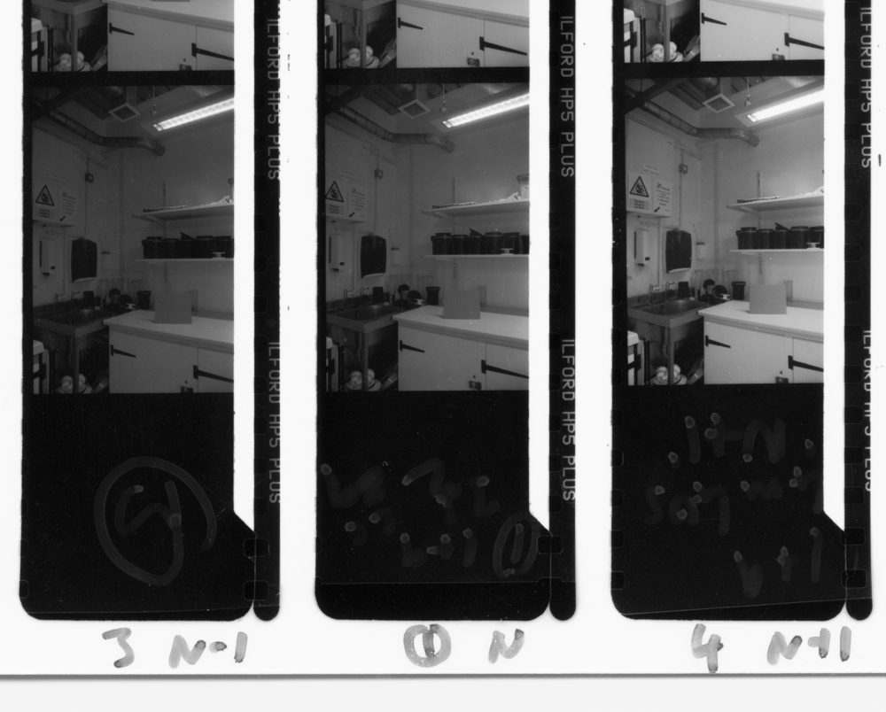 Contact print showing 'normal' development (centre), under-development (left) and over-development (right)