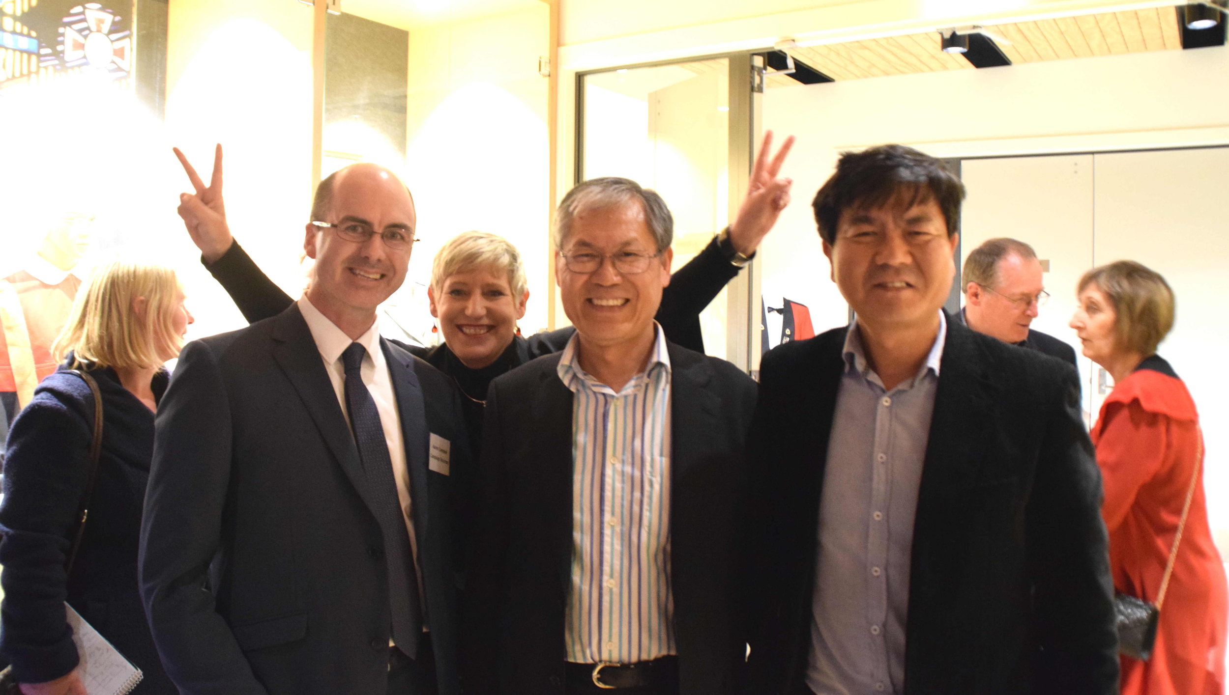 Mayor Lianne Dalziel (flashing the victory sign), with her campaign manager Aaron Cambpell (left), Councillor Jimmy Chen (middle), and Kevin Park of Canterbury Migrants Centre