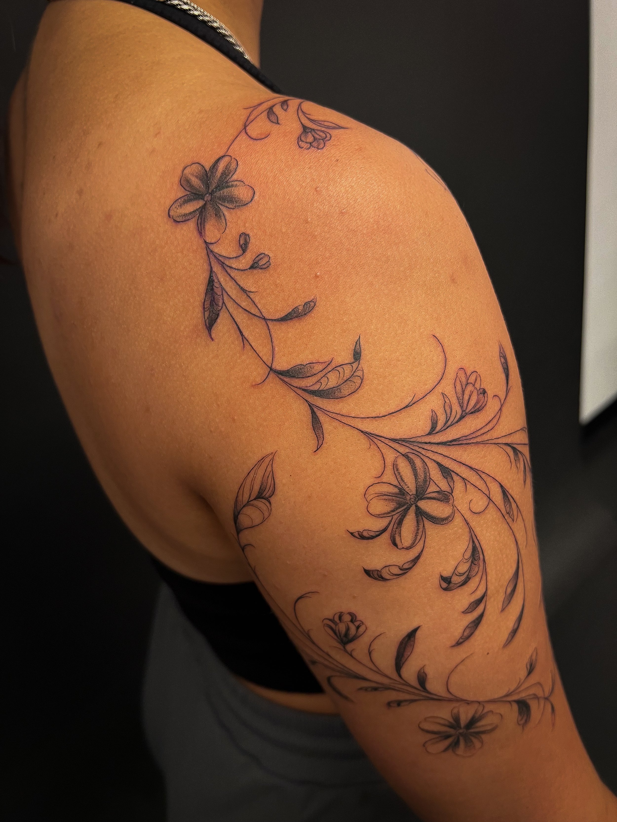 fineline floral flower scrolling tattoo with leaves