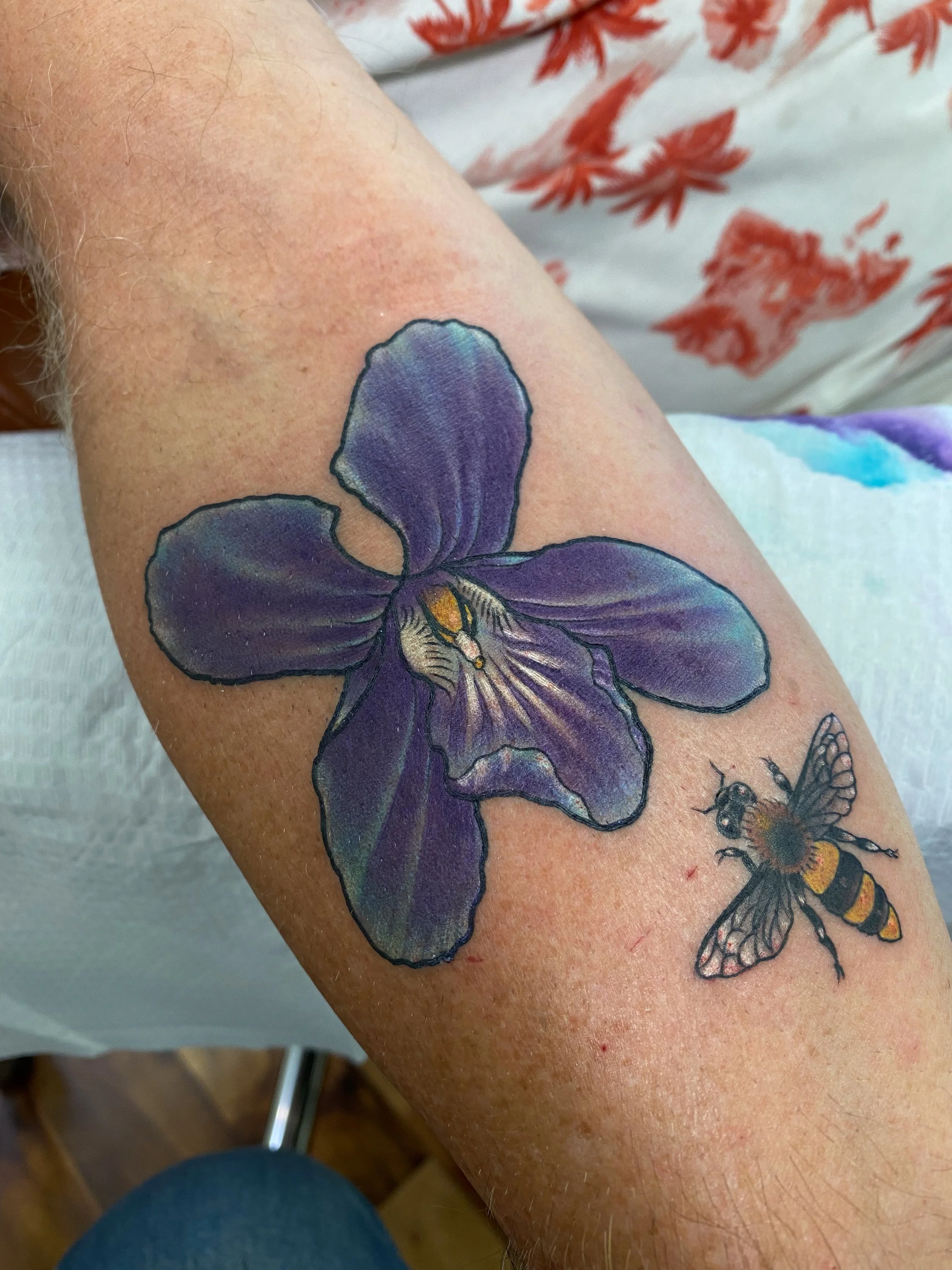 Purple illustrative orchid tattoo and bee