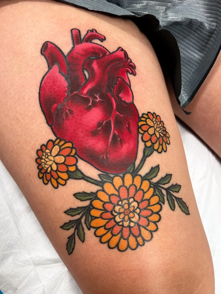 Neotraditional heart and marigolds tattoo.jpg
