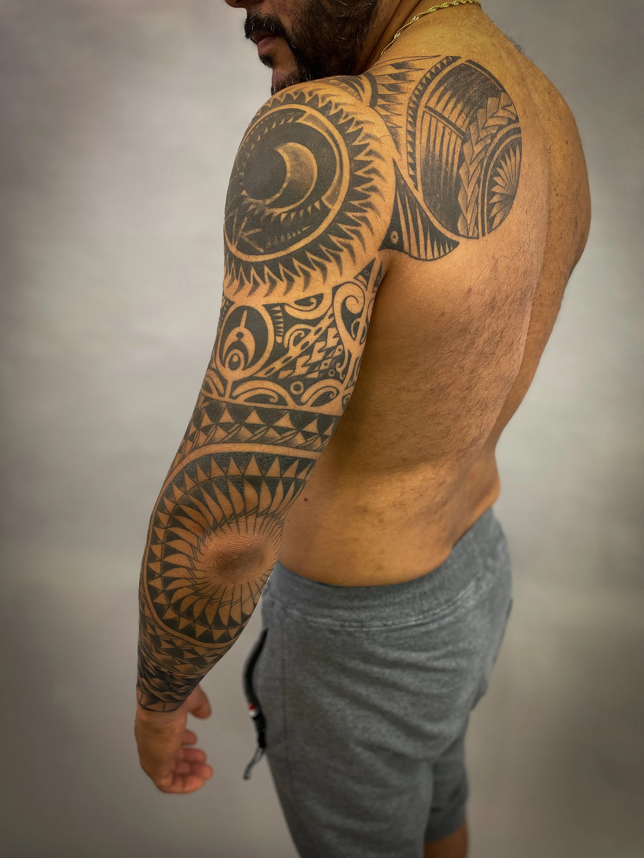 Geometric tribal polynesian chest and sleeve tattoo-3.jpg
