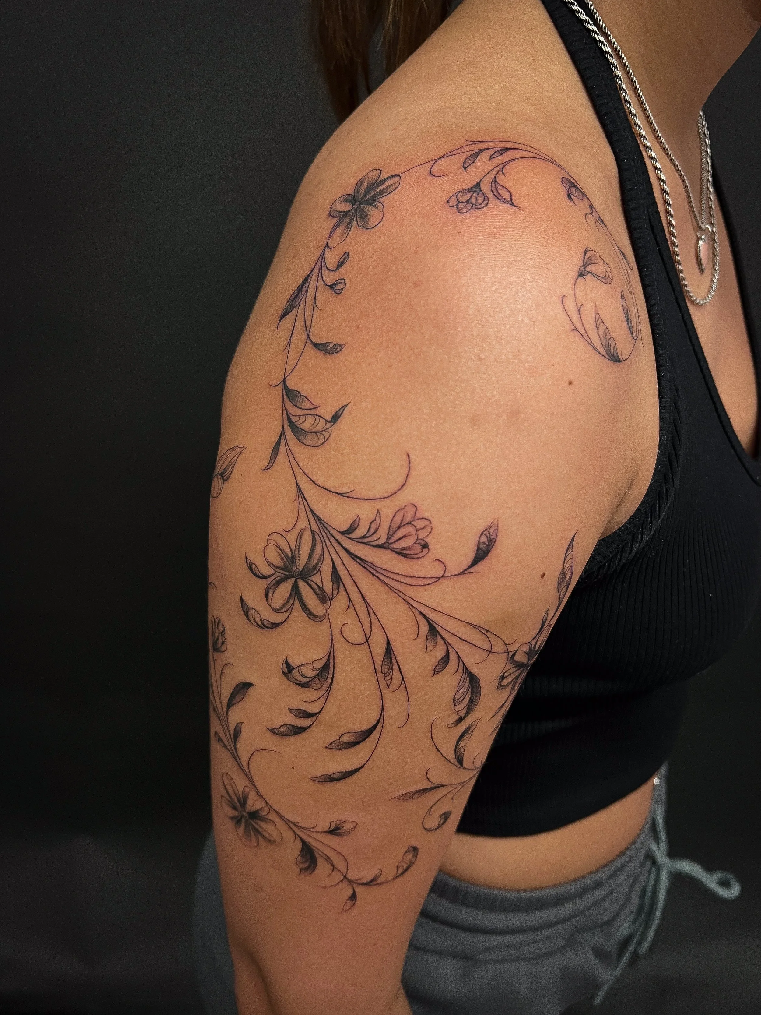fineline floral flower scrolling tattoo with leaves