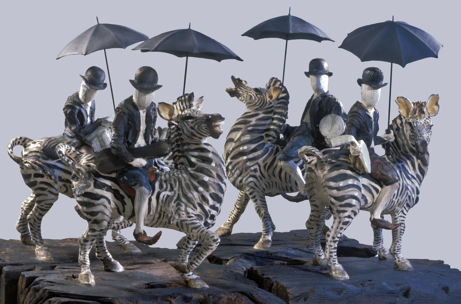 Les Troubadours du Roi Bédouin © 40 cm high x 80 cm wide Unique. Blank-faced, astride zebras, with their bowlers and brollies, sporting DJ’s, anatolian slippers, instruments and violin cases; the mood is dark and troubling: will they just recite roundels or round us all up?