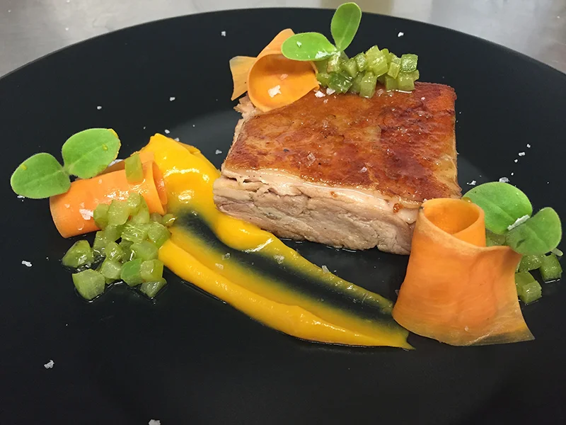 Cochinillo con puré de boniato ahumado y pimiento verde frito