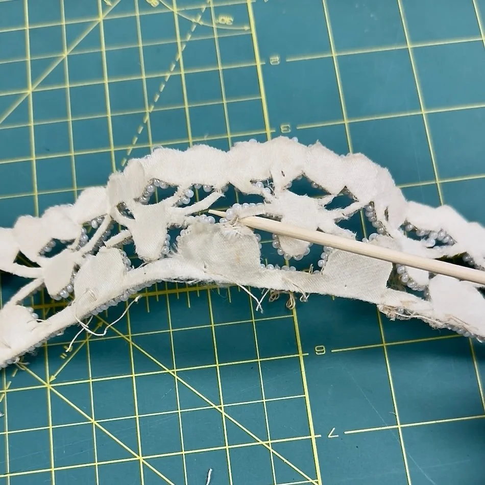 Inside of vintage 1950s beaded wedding crown showing breakage and fragility.