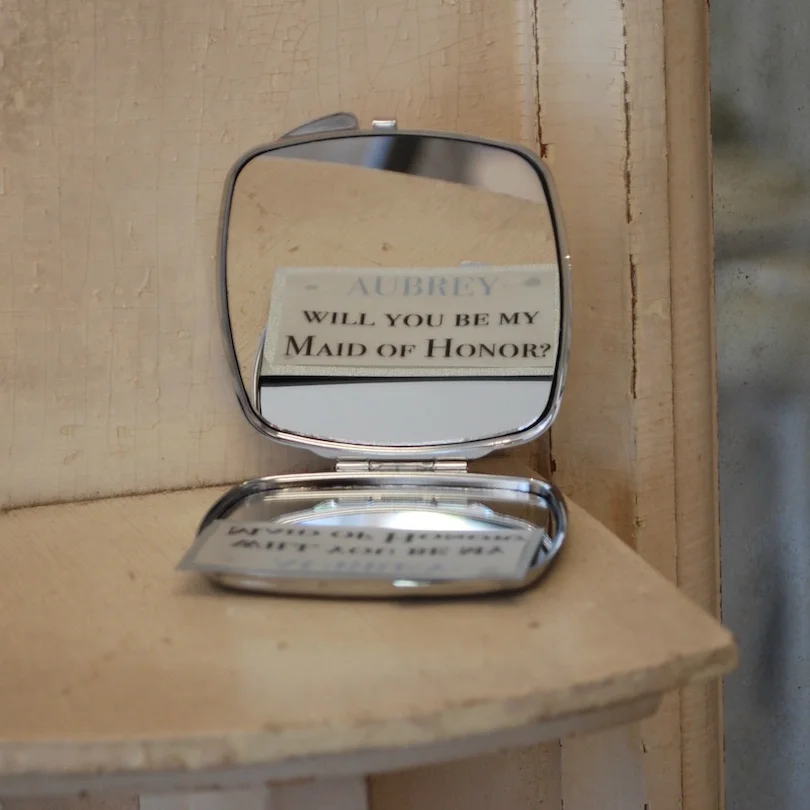 A personalized make-up mirror would be the key to asking her bridesmaids to be in her bridal party. Little vellum notes were tucked inside the mirrors in hopes they would discover her special invitation upon opening. A few friends were so happy to r…