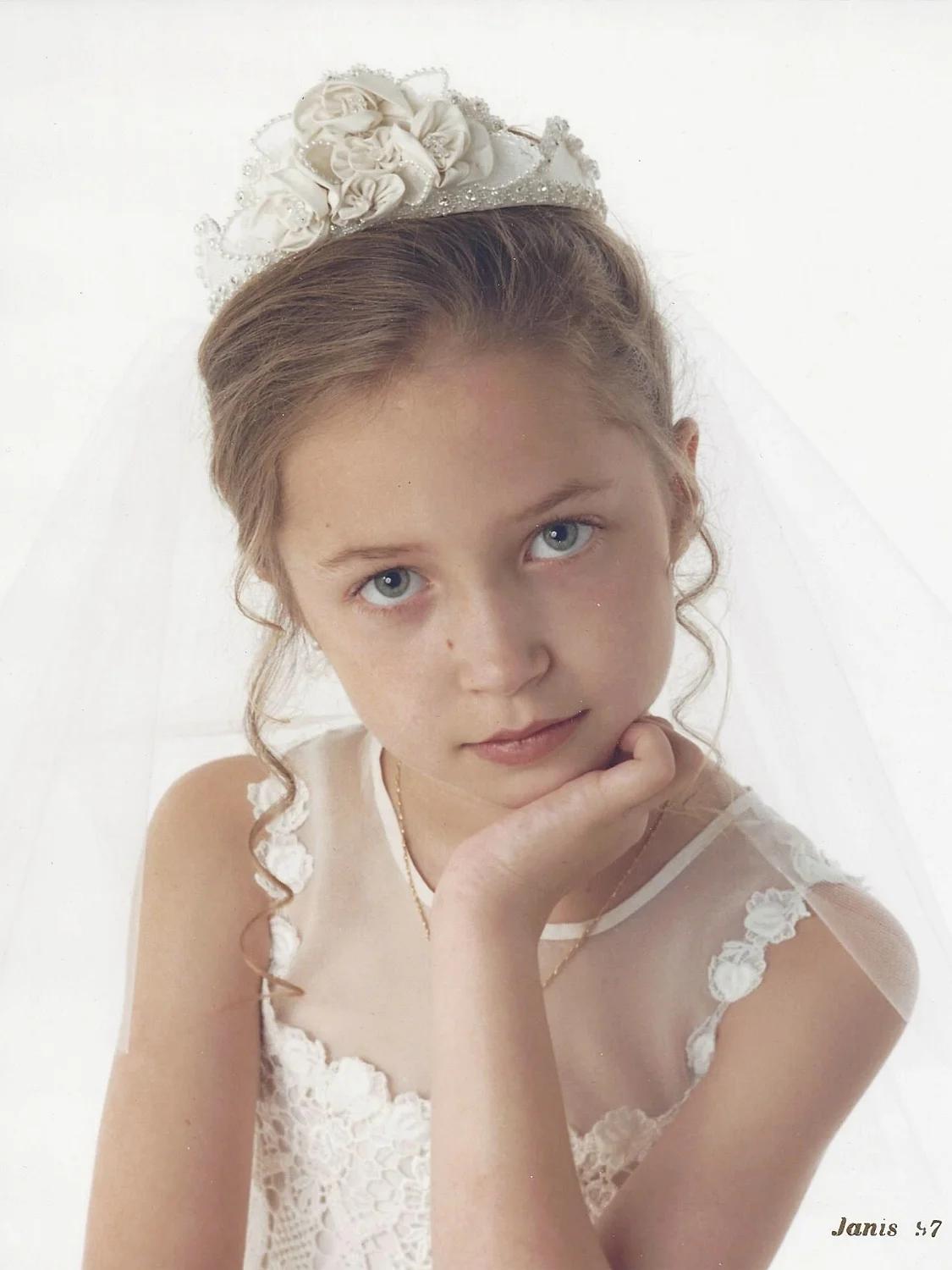 Brielle's holy communion dress and headpiece were designed from silk taffeta, silk organza, and French Guipure lace. Her 1997 dress design was a classic and could still be worn today.