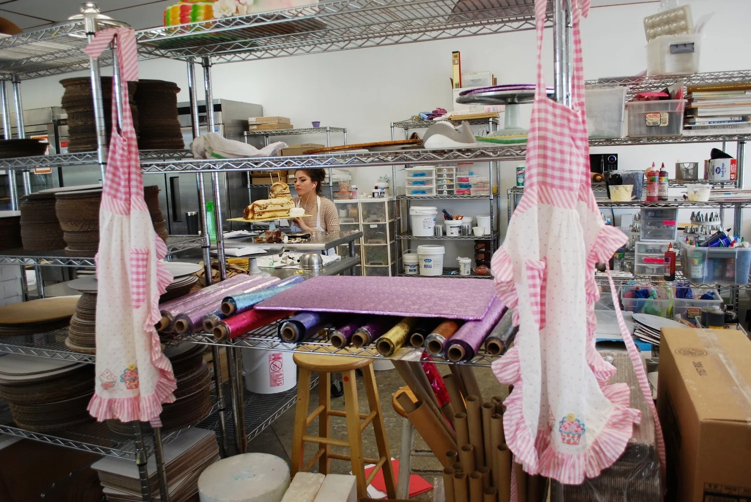 Loved this view of the master work station. The aprons reminded me of my beloved Grandma's collection.
