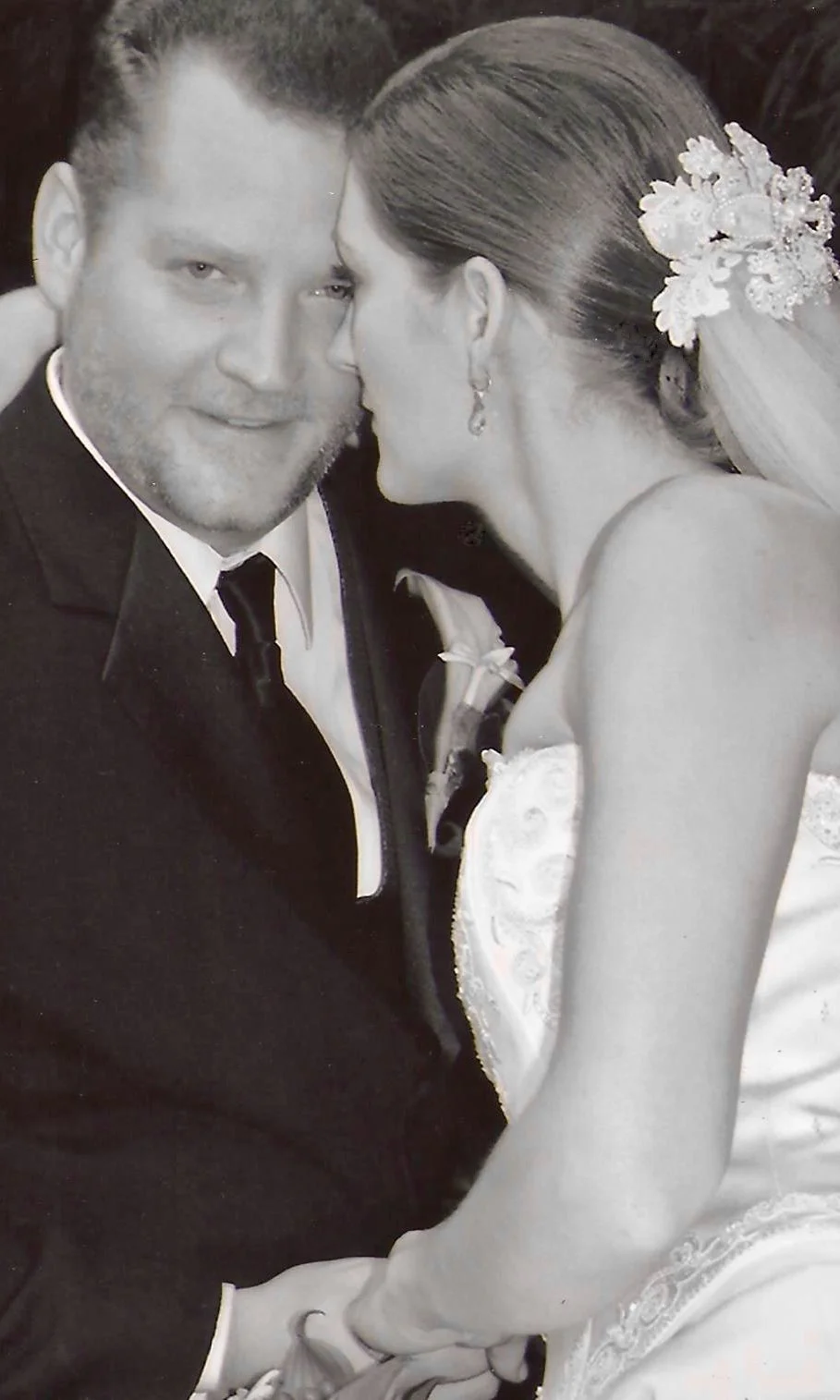 Bride looking at her husband wearing her mother's vintage headpiece restyled.