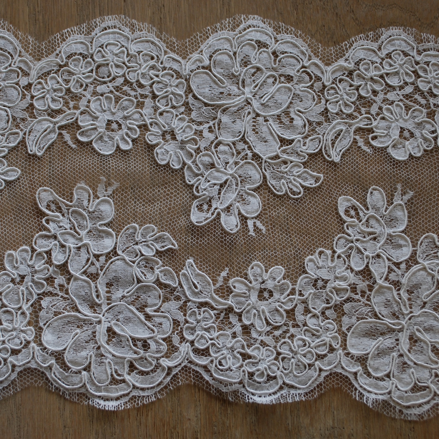 Alençon lace is a corded lace made on a sheer netting. It is pronounced (a-lonh-sohn).