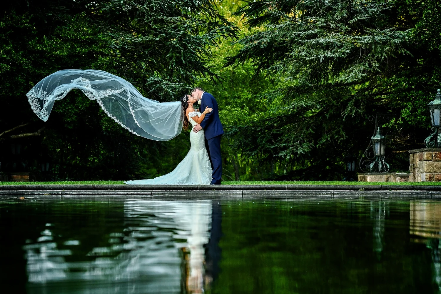 "This was one of our first photos taken after our ceremony. It was a quiet moment between Brian and me. We reflected on our marriage and the future ahead. I love how you can see the details of the elegant lace trim fluttering through the gentle breeze."