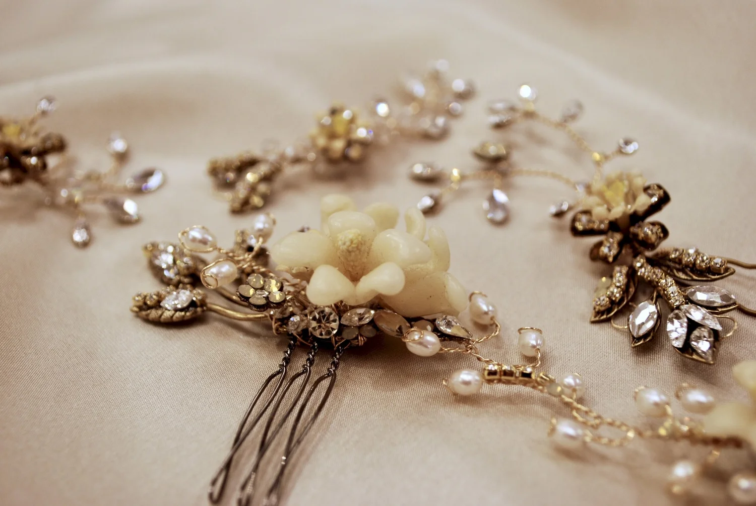 My idea for Antoinette was to create different pieces to give her the freedom to style them however she wished on her wedding day. She had gorgeous hair and tons of it! I used freshwater pearl, smoked opal, Swarovski stones and 14KG to surround her original vintage wax and make it come alive.