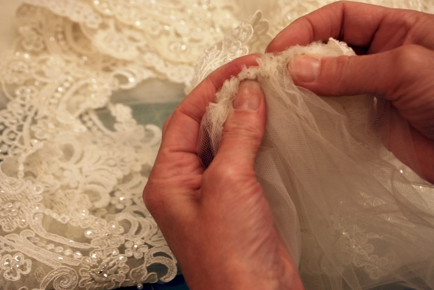 We removed the comb and found that the gathering stitches were large and rolled causing thickness resulting in bulk. I was able to modify the stitching and do a little magic with the lace.