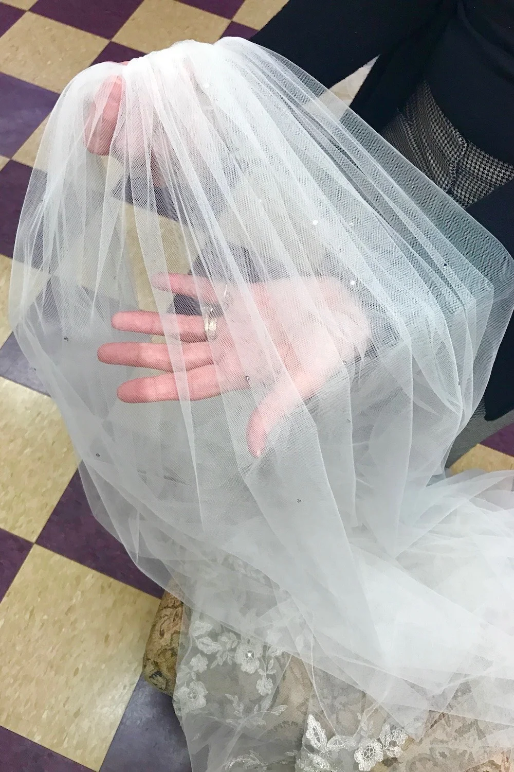 I suggested adding double backed crystals to the top of the veil and transferring it to a handmade wire frame for a couture finish.