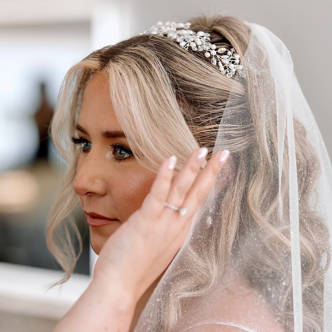 Jennifer envisioned a sparkly cathedral wedding veil to complement her Martina Liana princess style gown. We designed her veil in a luxurious imported sparkle net. 
I used my signature technique to design her pearl and crystal headpiece in three sepa