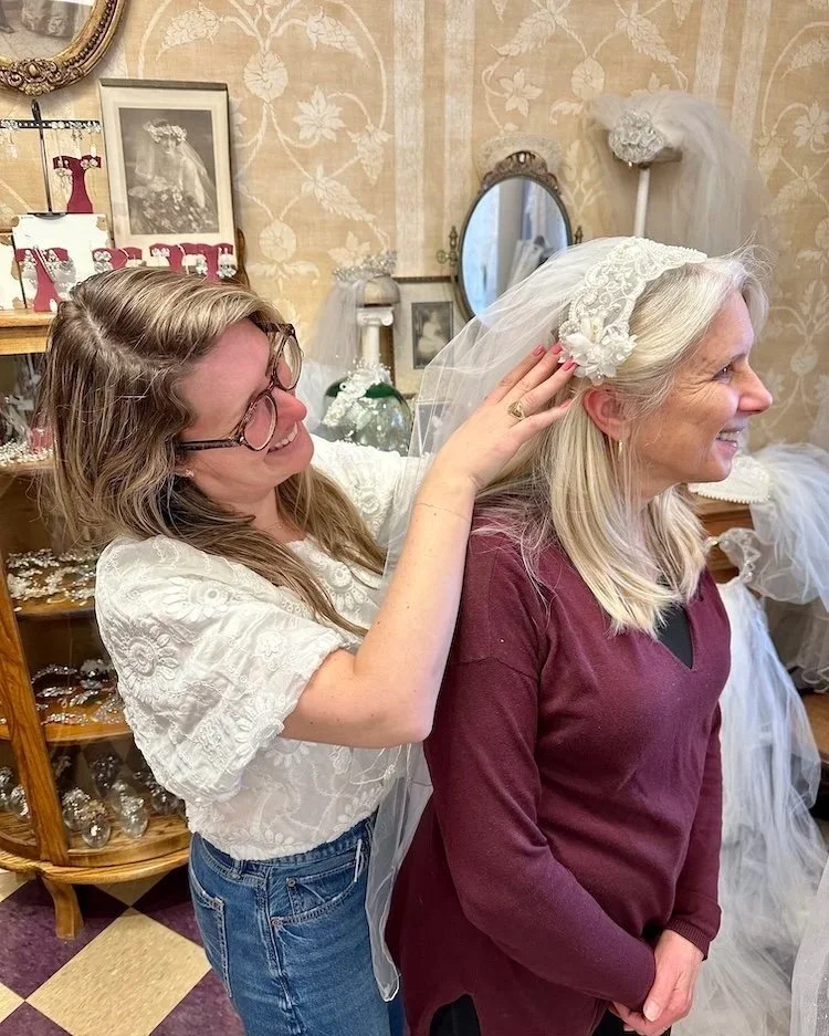 Bride-to-be putting her mom's 1983 headpiece on her mom during a visit to Headpiece.com.