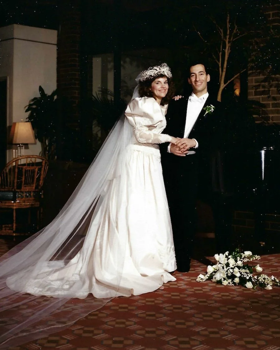1990 bridal portrait with bride wearing long veil and wedding dress with pouffy sleeves.