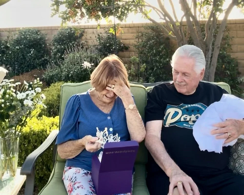 Grandmother in tears opening Headpiece.com purple box with her recreated vintage wedding crown.