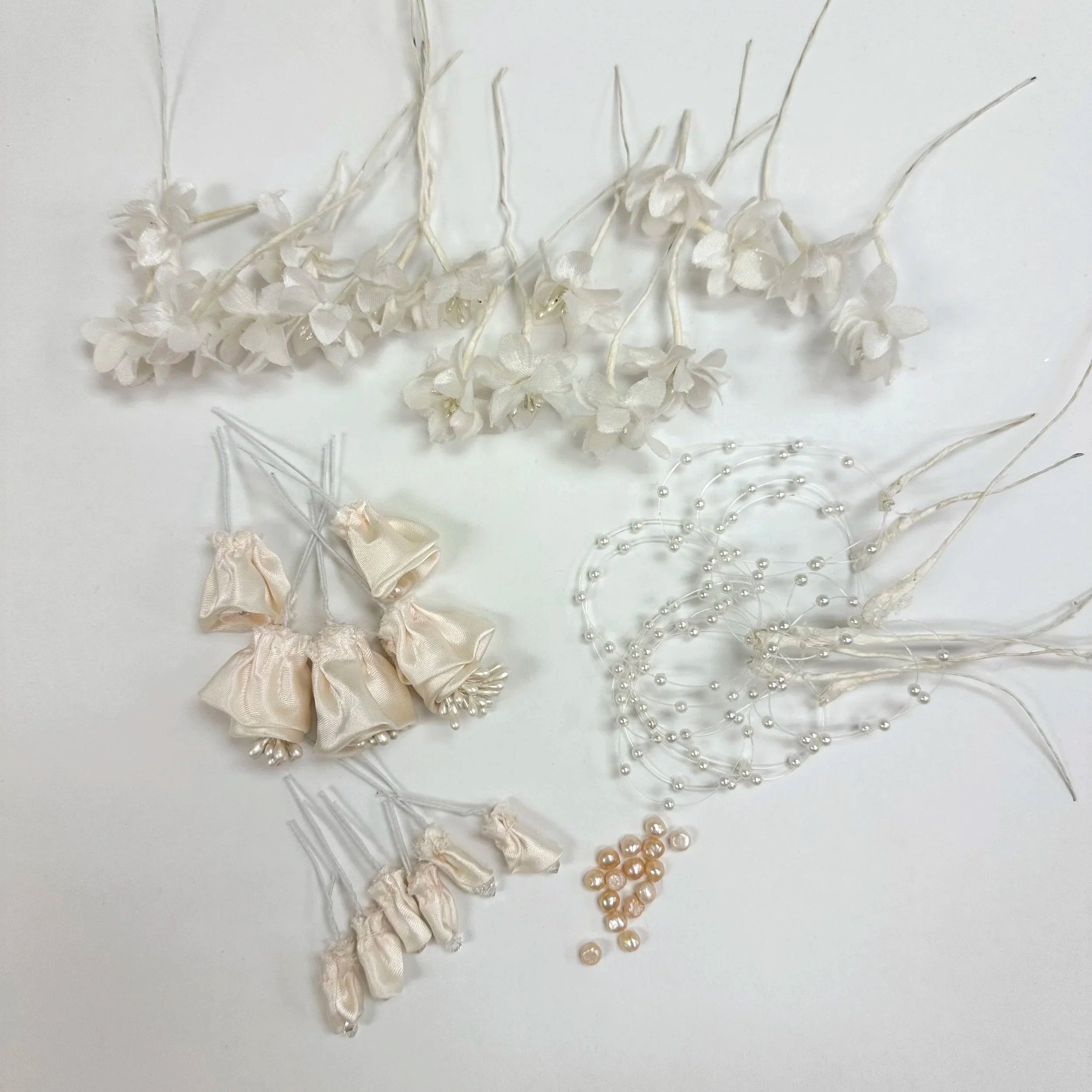 Deconstructed vintage headpiece components downsized and ready for redesign.