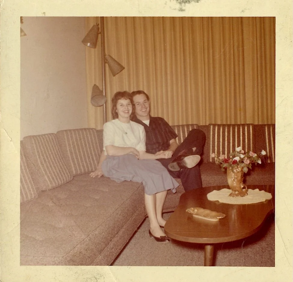 Vintage photo of two high school lovers sitting on the couch after the dance.