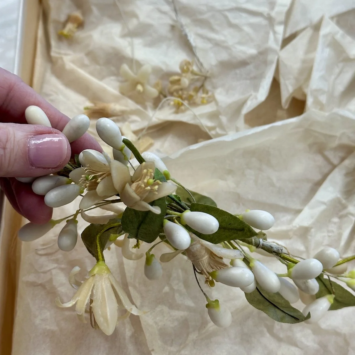 Vintage wax flowers donated by a bride after restoring her grandmother's headpiece.
