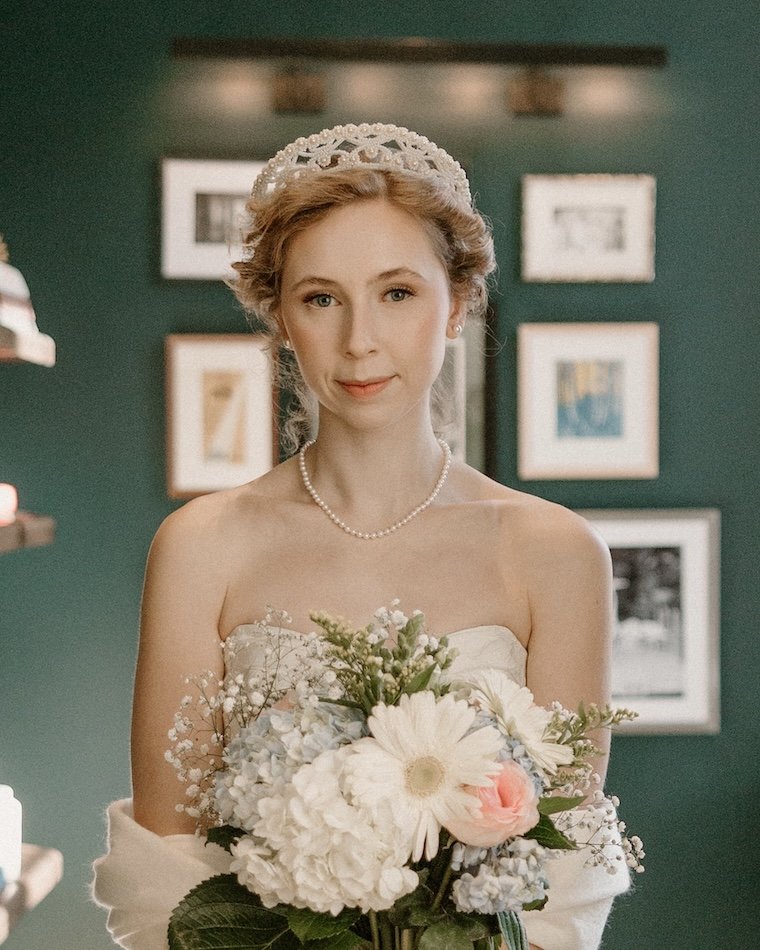 Bride wearing her grandmother's 1953 beaded wedding crown holding her bouquet.