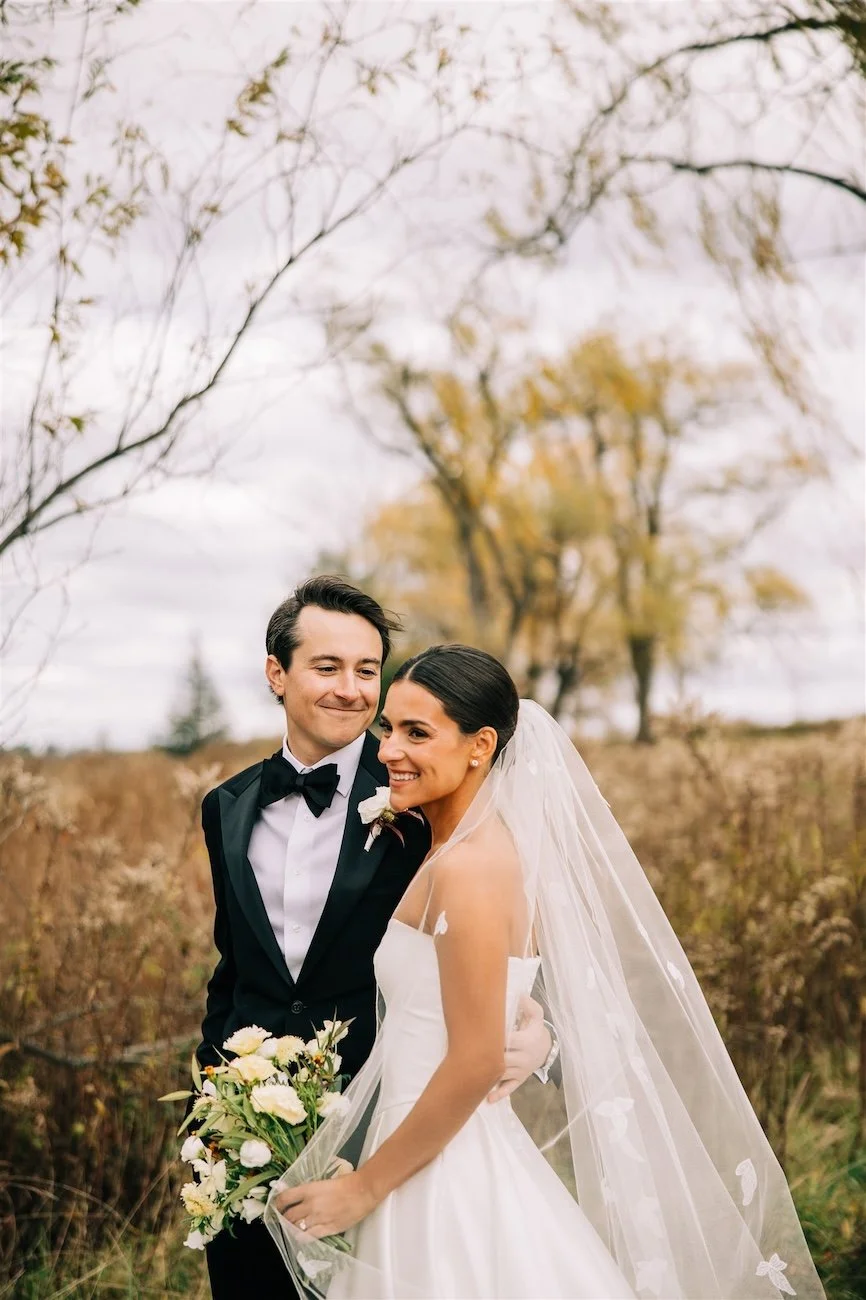 Groom admiring his stunning bride during a first look on a beautiful fall day at Inness.