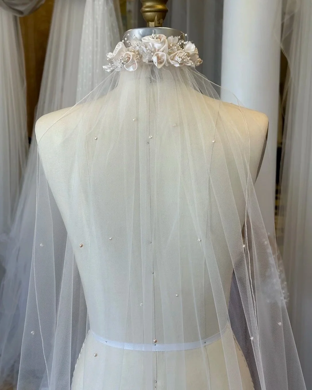 Mom's 90s respurposed blush headpiece pinned on a mannequin with a new custom veil with hand sewn blush freshwater pearls.