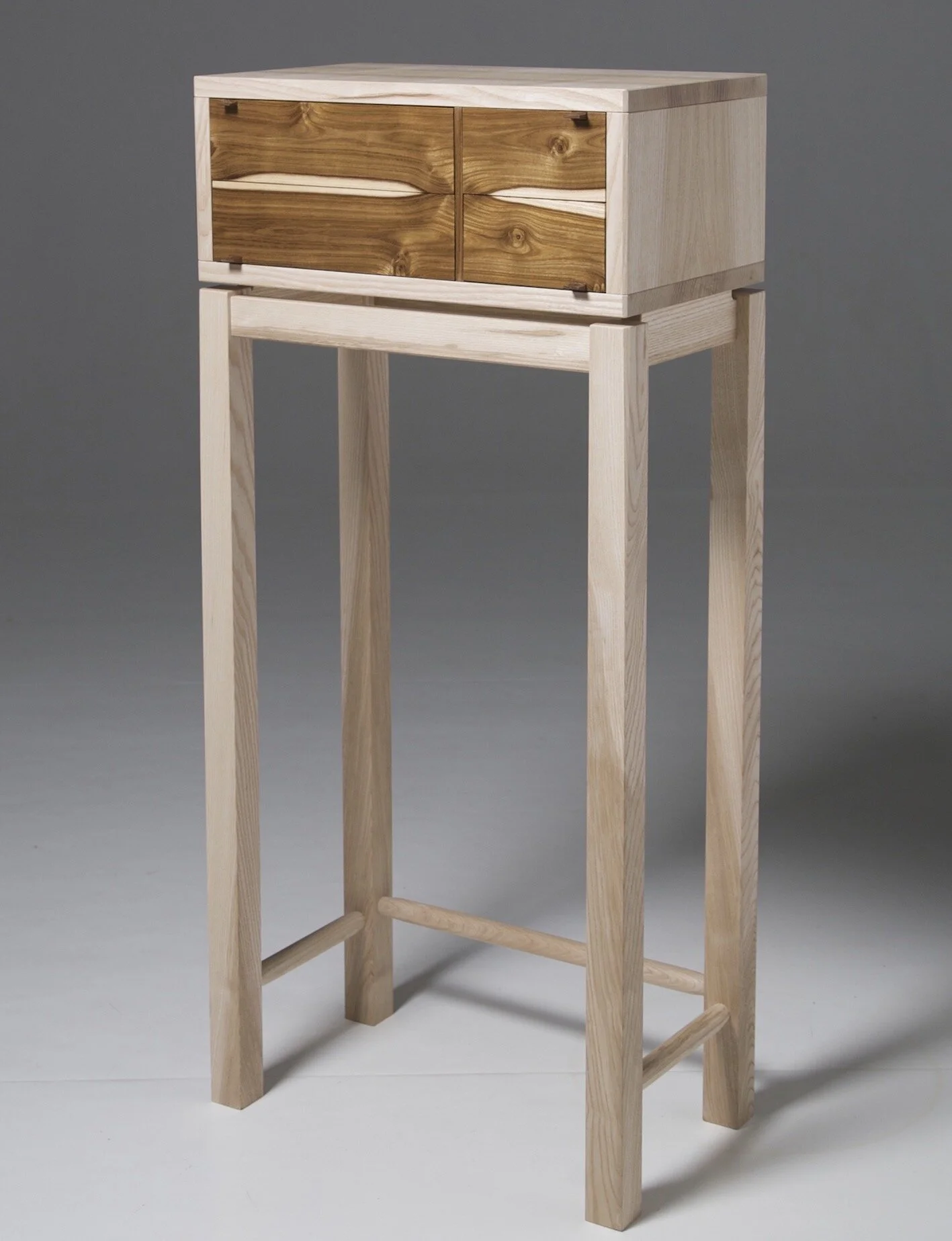 chest of drawers on a stand