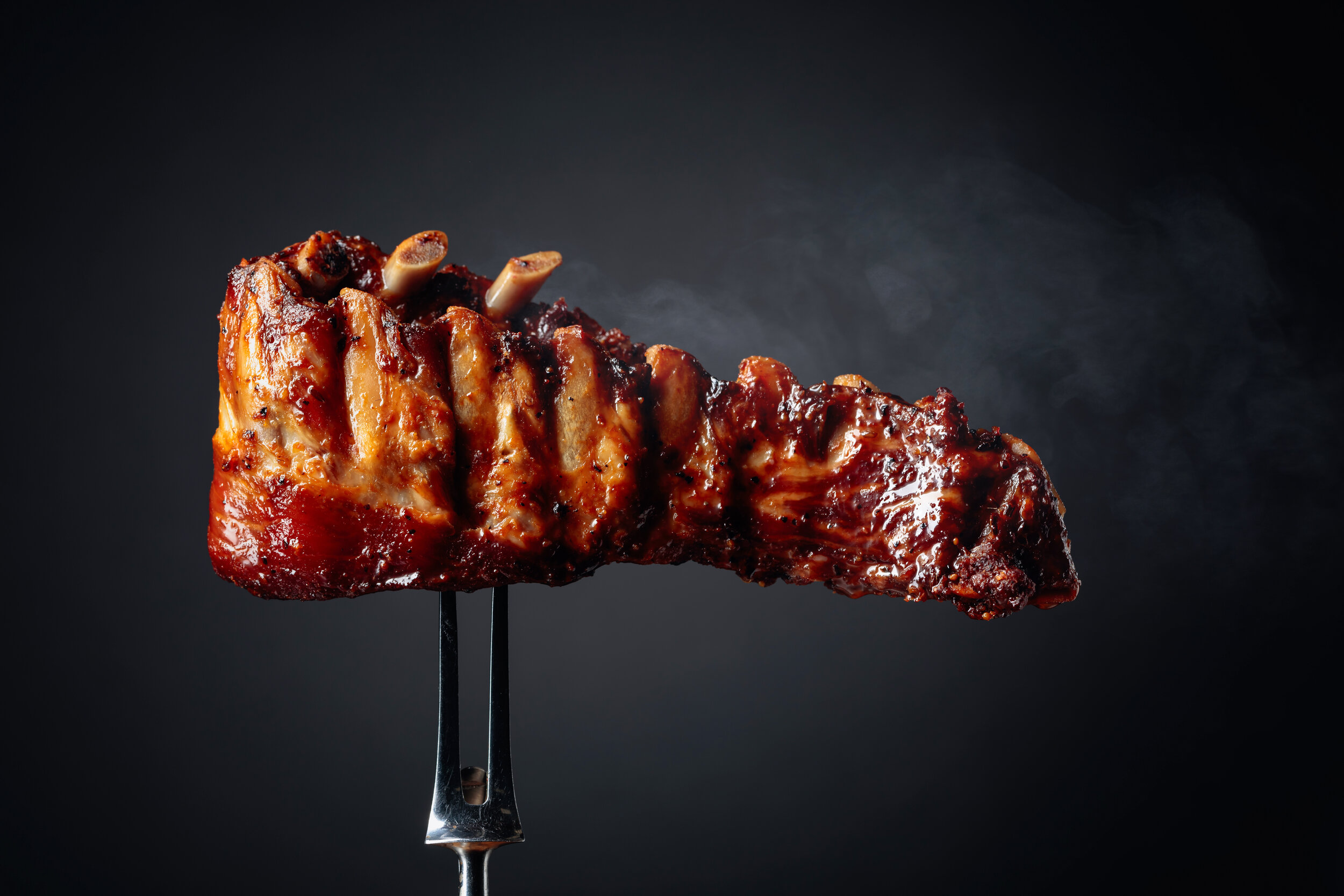 Grilled-pork-ribs-on-a-fork.-1198197385_8660x5773.jpeg