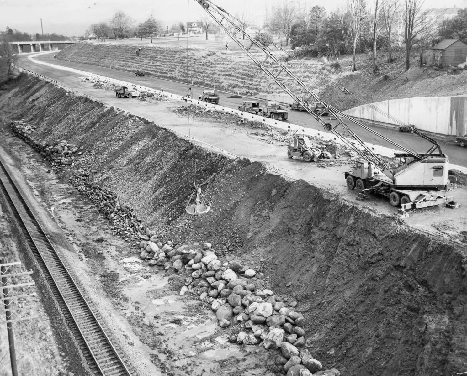 1957 Banfield, repairing slide damage, Lloyd Golf Course upper right. OHS bb015411