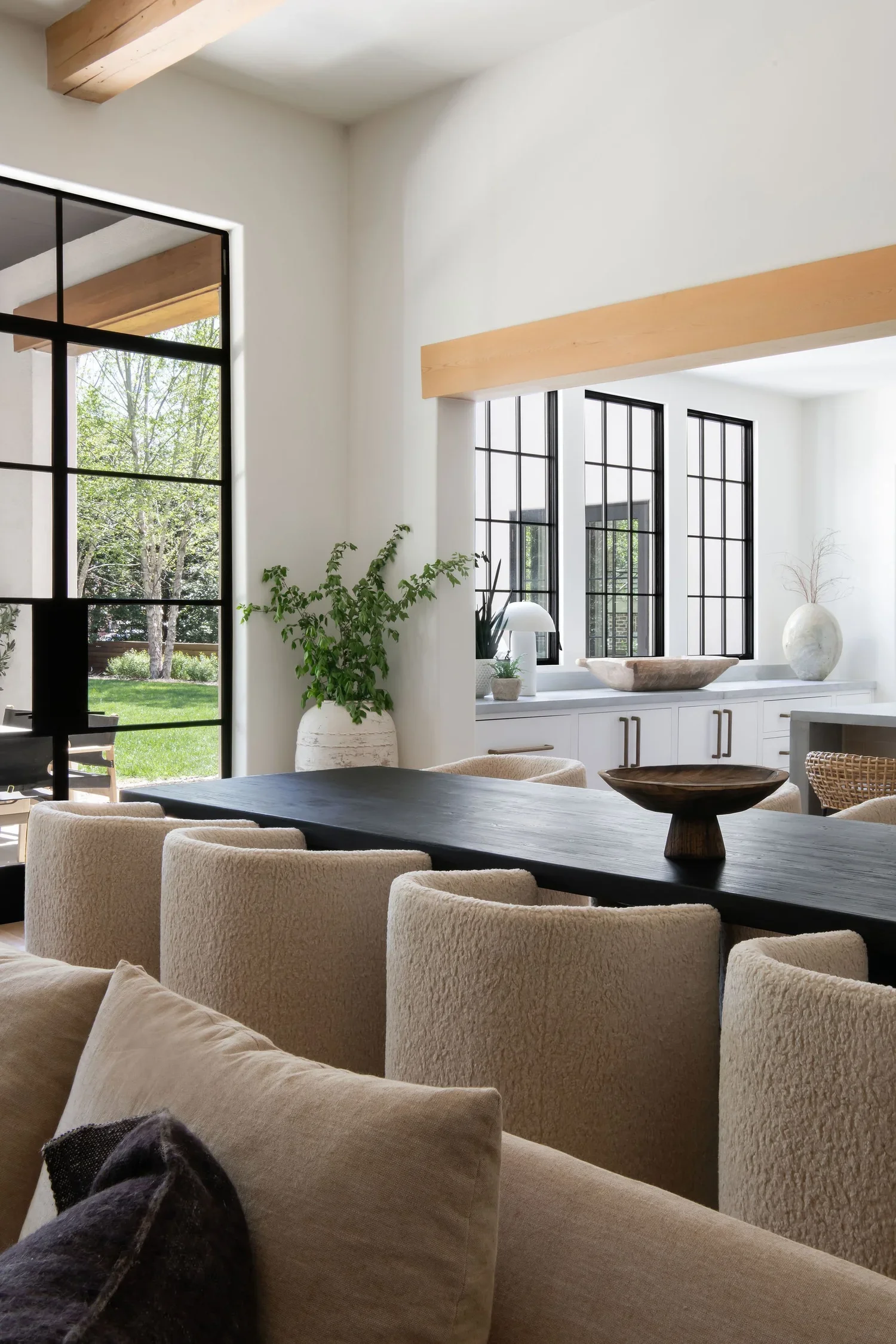 home interior, interior design, kitchen, dining table, beige chairs, window light, vase with plant 