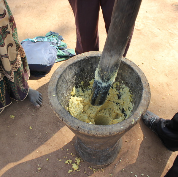 Mashing Soya beans to powder/flour prior to drying in the sun.