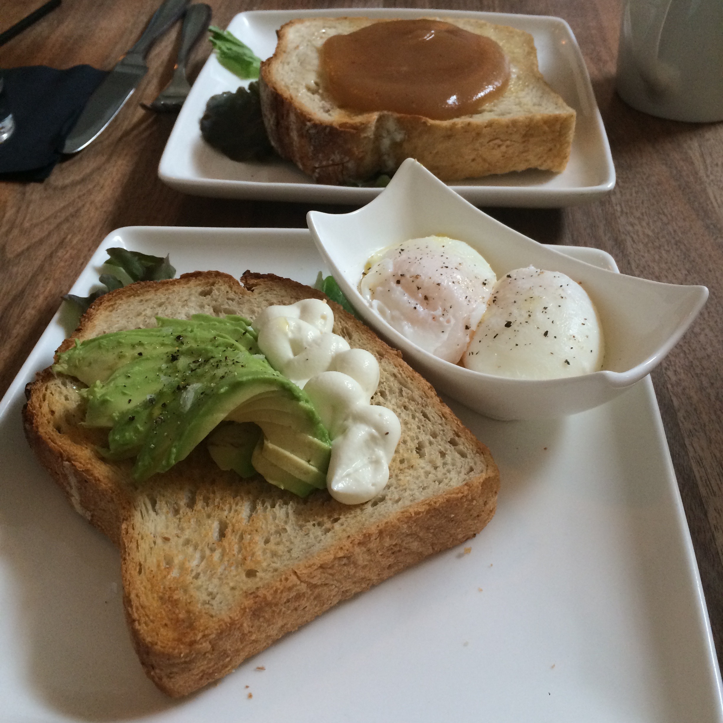 Toast with avocado and goat cheese mousse, side of poached eggs, and toast with apple butter. (Photo by Arielle Weg)