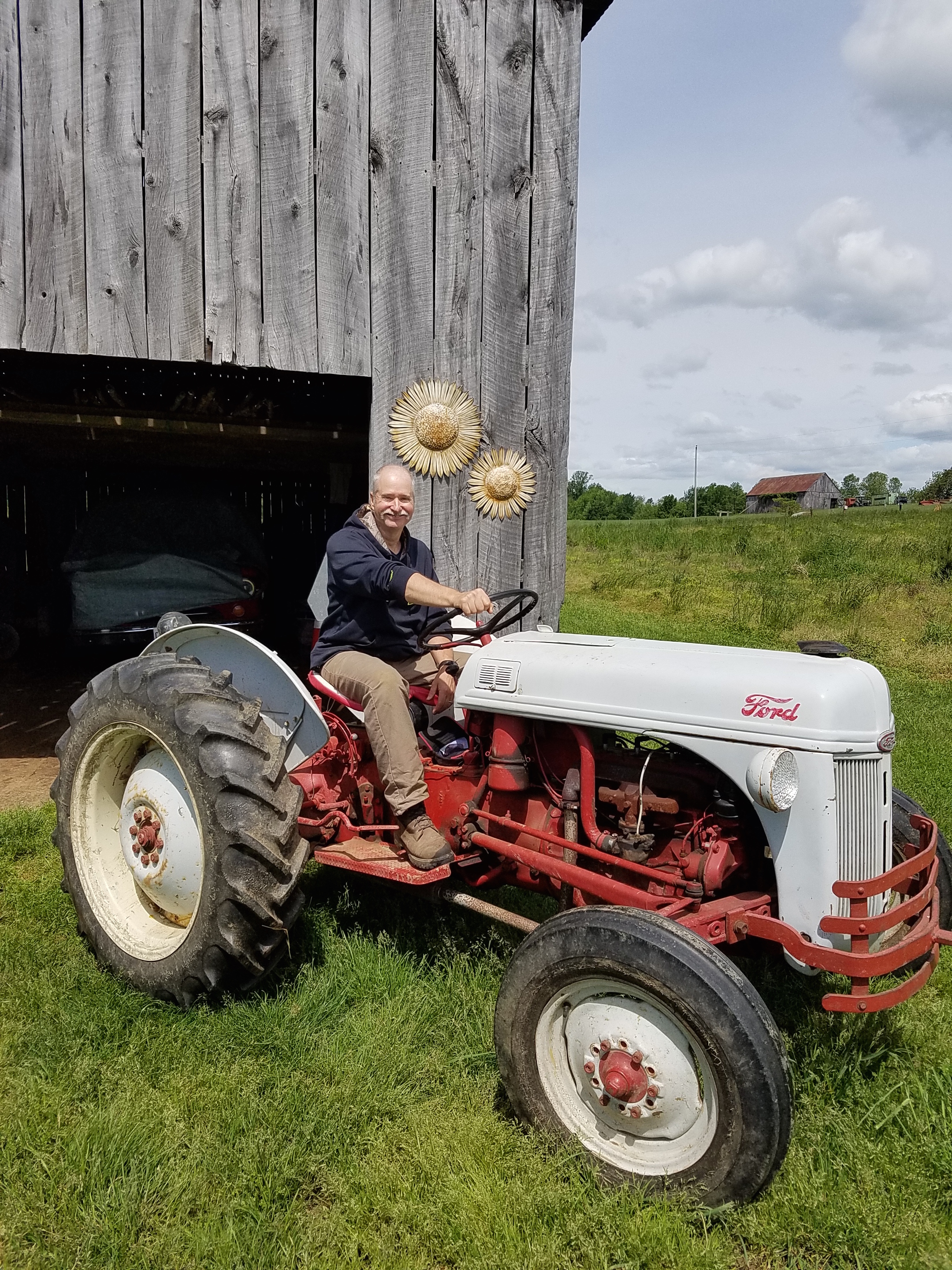 Former firefighter, Gary Palmer, rides his vintage tractor at Holiday memories Farm. (Photo by Susan Able)
