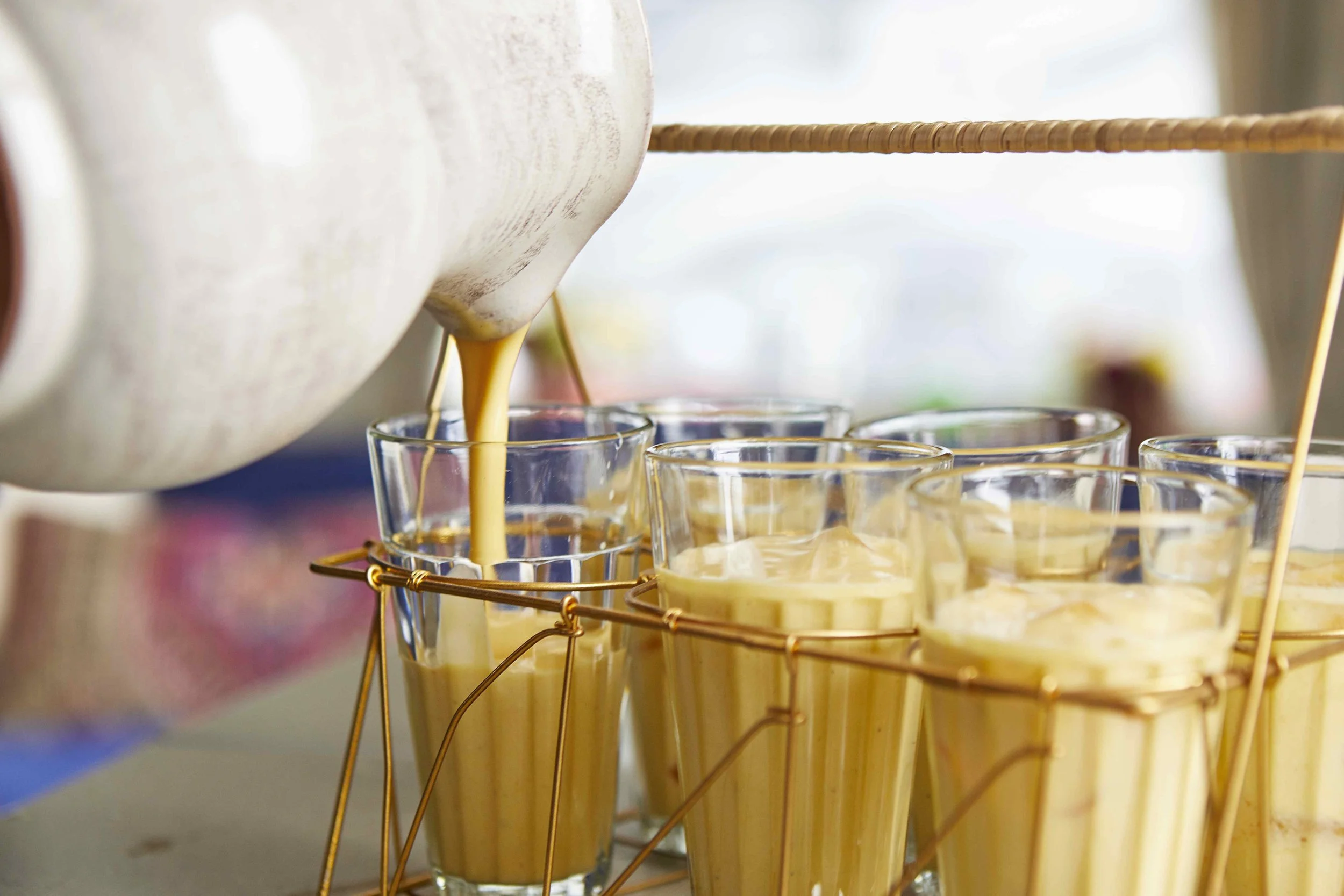 Mango lassi is a must have with spicy food. To make a serving for eight, blend 64 ounces of full-fat, plain yogurt, 2 cups of mango pulp, 1/2 teaspoon green cardamom powder, honey or sugar to taste and a couple of ice cubes. Voila!