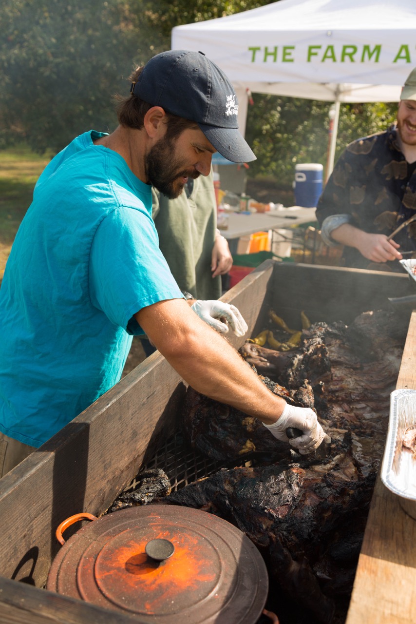 Casey from the Farm at Sunnyside prepares a wood roasted pig.
