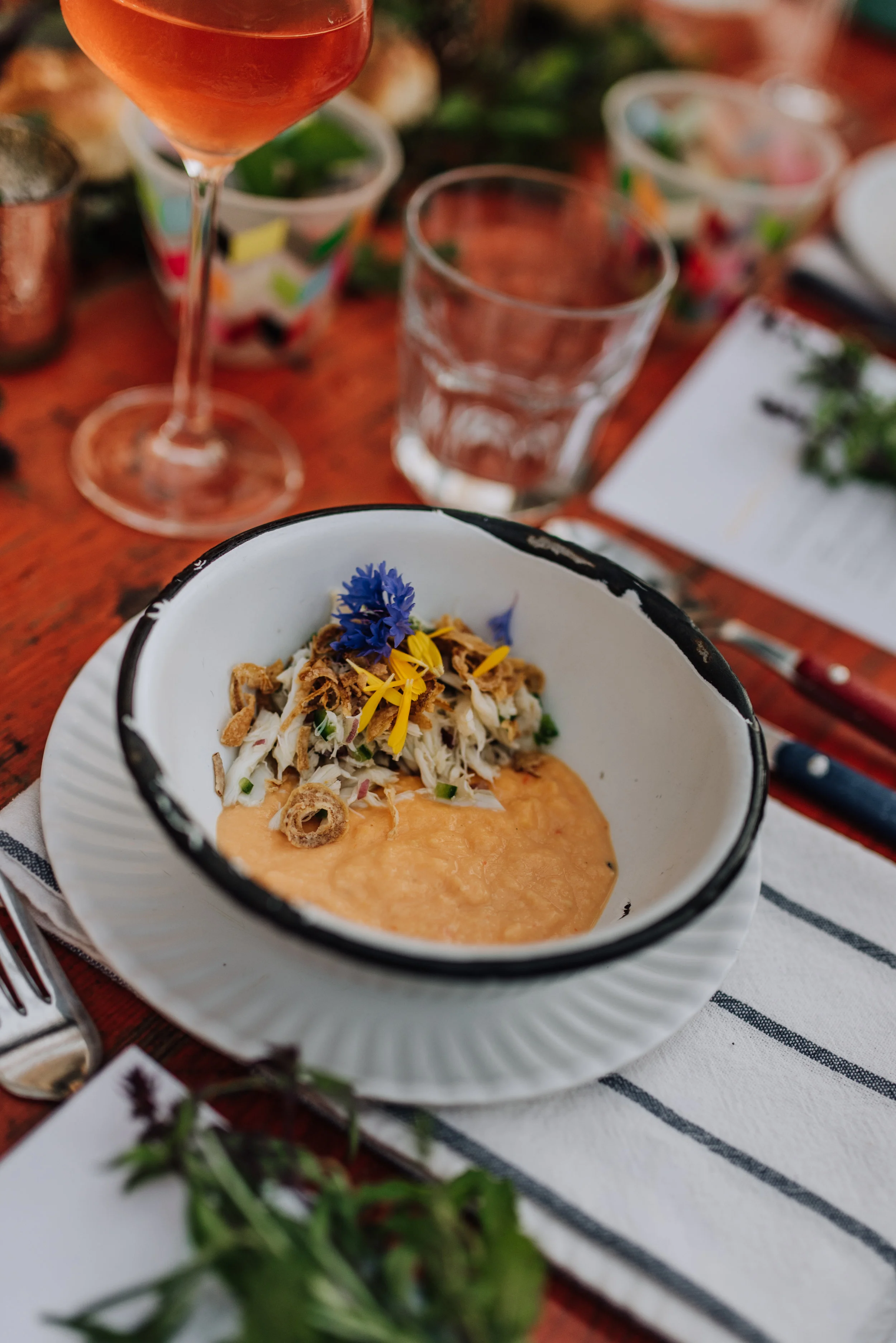 Humita made with Spring Valley Farm & Orchard corn, crab and crispy onion and paired with ANXO Cider.