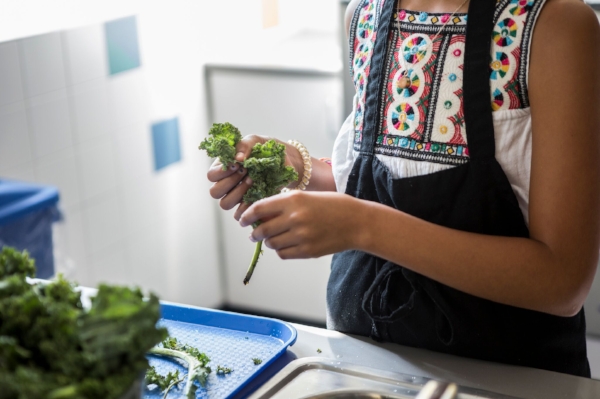 Lucia García helps prepare a kale-and-sweet-potato salad.