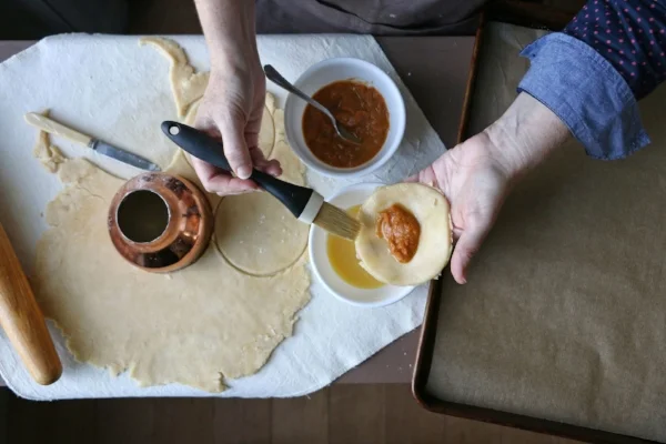 The egg wash acts as a “glue” to help seal the dough of the hand pie.