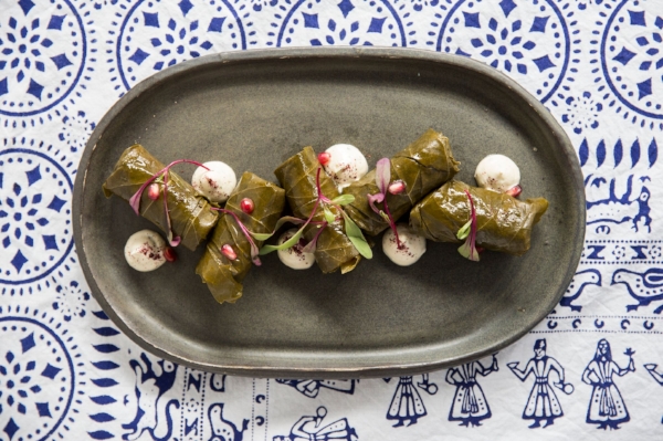 Bostneuli tolma, or grape leaves stuffed with rice, vegetables, and yogurt, make for an excellent opening dish.
