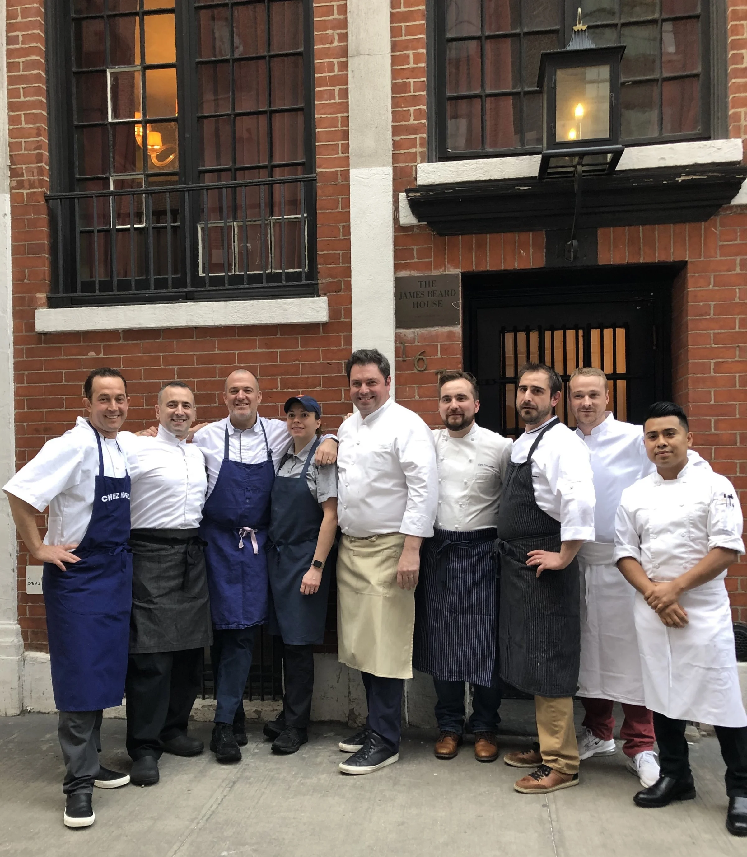 A gathering of french chefs from dc and baltimore and their assistants, in front of the james beard house in greenwich village.
