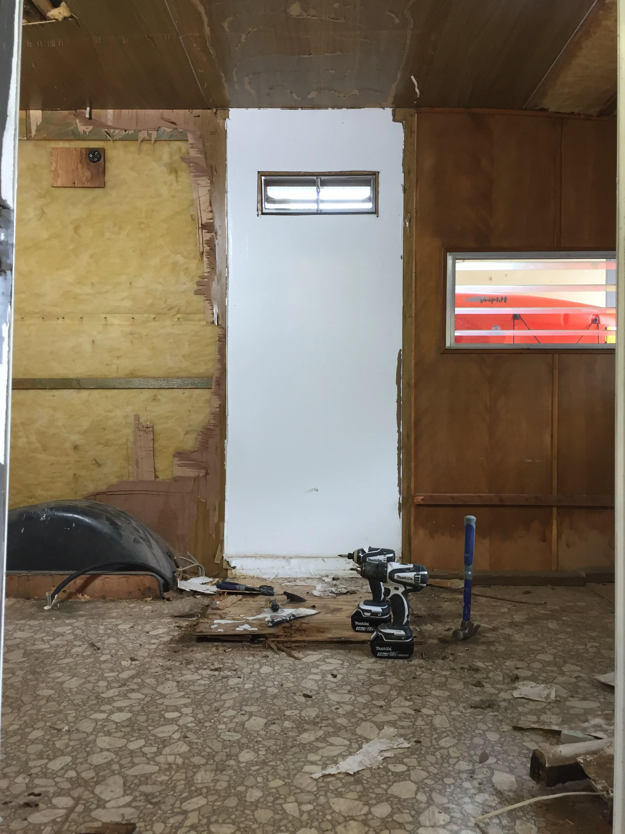 The last remaining piece of shower wall left + that dang plywood shower subfloor.